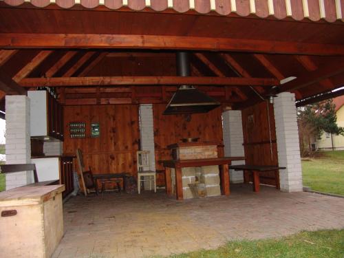 a wooden pavilion with a table and a bench at Chalupa v Pokrkonoší in Rtyně v Podkrkonoší