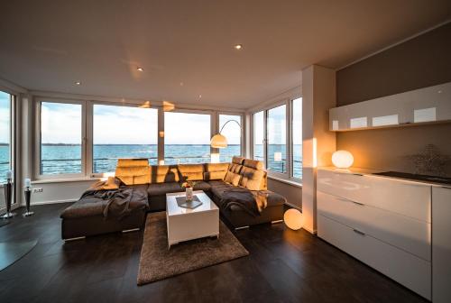 a living room with a couch and a table at Goitzsche Resort in Bitterfeld