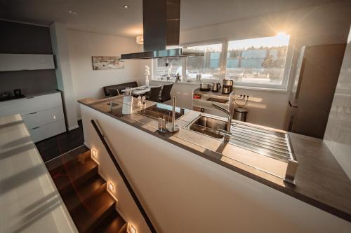 a kitchen with a sink and a counter top at Goitzsche Resort in Bitterfeld