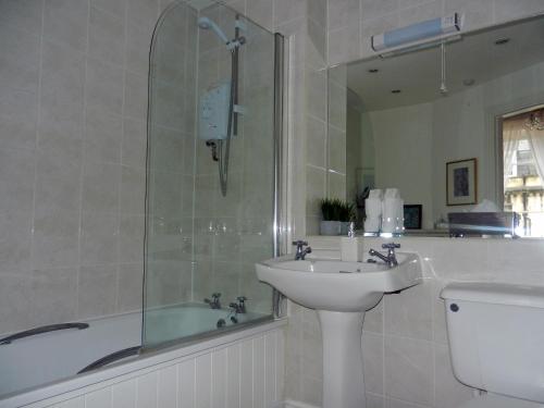 a bathroom with a sink and a shower and a tub at Brocks in Bath