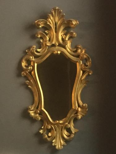 a gold mirror hanging on a wall at La Rocca Guest House & Spa in Montefalco