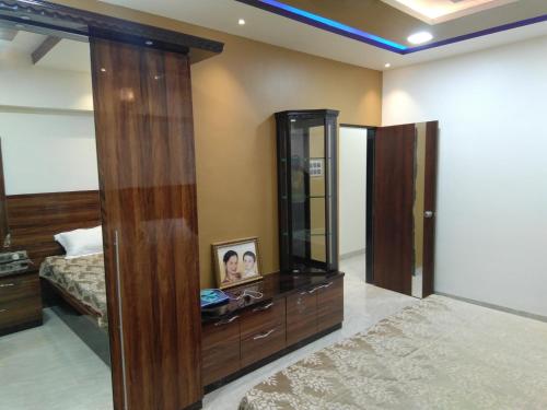 a bedroom with a bed and a large mirror at Balani House in Navi Mumbai