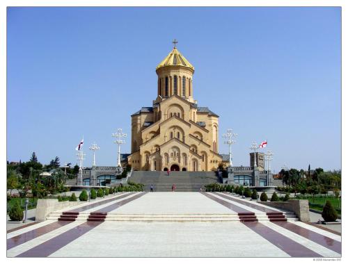 a large building with a tower on top of it at Apartments on Akhalubani St 2 in Tbilisi City