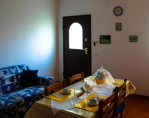 a living room with a table and a couch at Margherita Friendly house in Almè