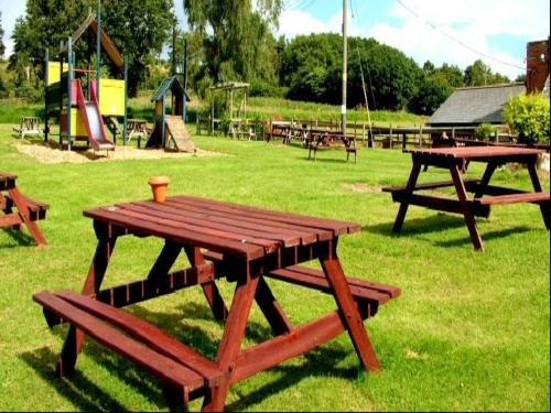 a group of picnic tables in a park at Blue Ball Inn, Sandygate, Exeter in Exeter