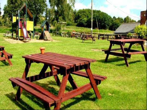 
a picnic table set up in a grassy area at Blue Ball Inn, Sandygate, Exeter in Exeter
