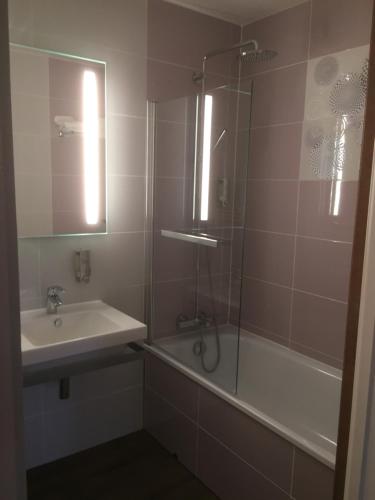a bathroom with a sink and a shower and a tub at Le Clos De Mutigny in La Chaussée-sur-Marne