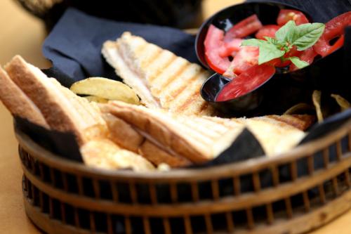 a basket filled with crackers and tomatoes and a salad at island in Pefki