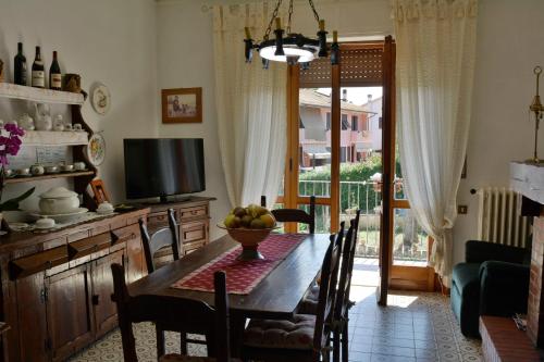 a dining room with a table with a bowl of fruit on it at Villa La Meridiana in Luciana