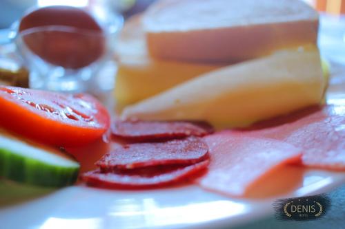 a pile of fruit and vegetables on a plate at Hotel Denis in Pristina