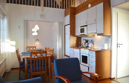 een keuken en eetkamer met een tafel en stoelen bij Pointin Vale Apartment Tahko in Tahkovuori