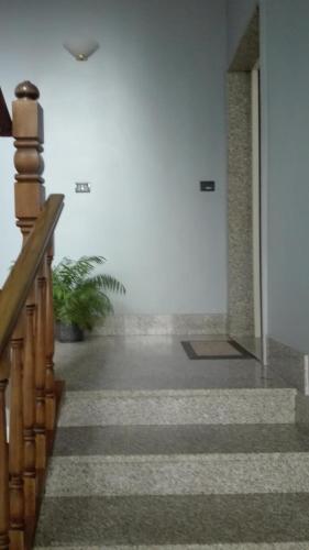 a hallway with a stairway with a stair case at Appartamento caneve in Arco