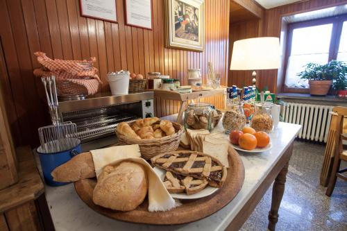 a table with bread and other foods on it at Hotel Funivia in Courmayeur