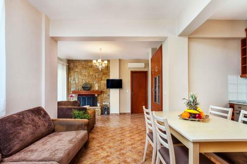 a living room with a couch and a table at Sunset Villas in Possidi