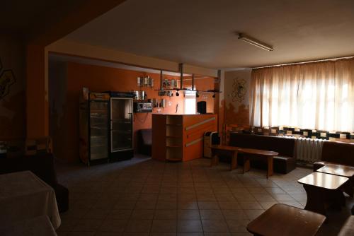 a living room with a kitchen and a dining room at Hostel Ruxandra in Focşani