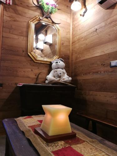 a teddy bear sitting on a counter in a room at Hotel Edelweiss & SPA in Cesana Torinese