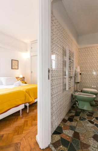 a bedroom with a bed and a bathroom with a toilet at Apartamento Vintage 2 in Porto