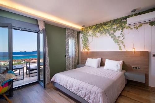 a bedroom with a bed and a balcony at Semiramis Luxury Suites in Chrysi Ammoudia