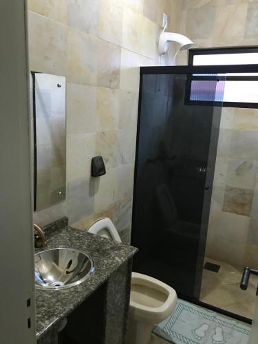 a bathroom with a sink and a toilet at Casa 4 Quartos Praia dos Ingleses in Florianópolis