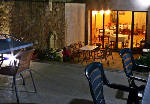 an outdoor patio with tables and chairs and a table and chairs at Hostal La Fuente in Buera