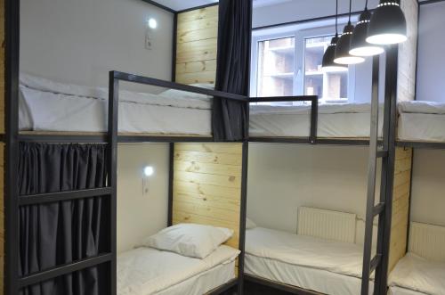 a group of bunk beds in a room with a window at Eco Hostel DROVA in Lviv
