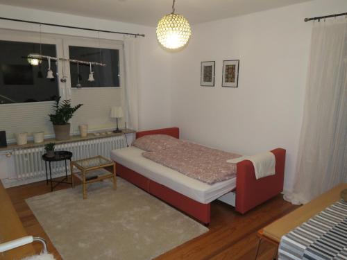 a small bedroom with a bed and a window at Marigold in Neumünster