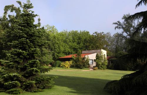 a house in the middle of a green yard at Jardin de Carrejo in Cabezón de la Sal