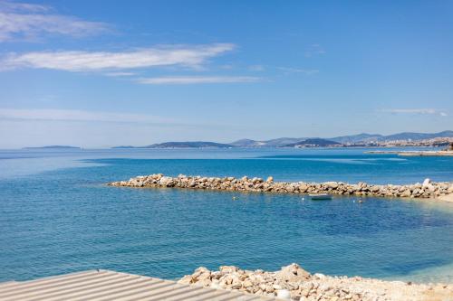 a small island in the middle of a body of water at Rooms Marinac in Podstrana