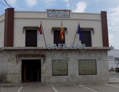 a building with three flags on top of it at Cuatro Caminos in Piedrabuena