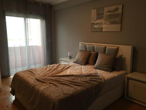 um quarto com uma cama grande e uma janela grande em INVICTA HOUSE MARQUÊS no Porto
