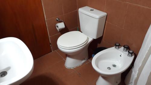 a bathroom with a white toilet and a sink at Dos Soles in Mina Clavero