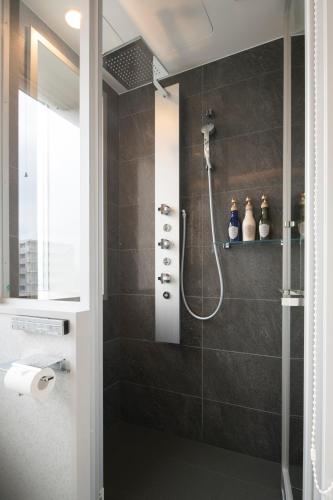 a bathroom with a shower with a glass door at Piazza Hotel Nara in Nara
