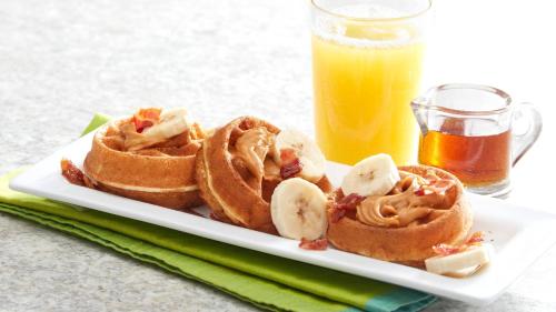 a plate with waffles and bananas and a glass of orange juice at Eisenhower Hotel and Conference Center in Gettysburg