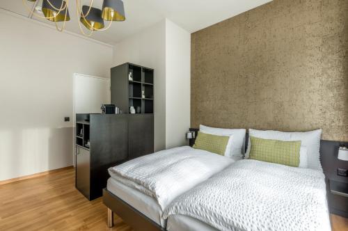 a bedroom with a large bed and a wall at Boutique Hotel KARL in Luzern