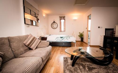 a living room with a couch and a bed at Spring Meadow in Worcester