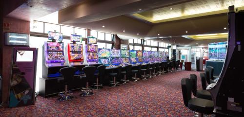 a row of video game machines in a casino at Hôtel du Casino de Capvern in Capvern