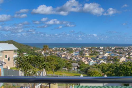 a view of a residential neighborhood with houses and the ocean at The Lookout Guest House in Port Alfred