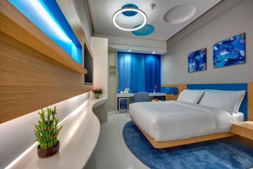 a bedroom with a large bed and blue lights at Al Khoory Inn Bur Dubai in Dubai