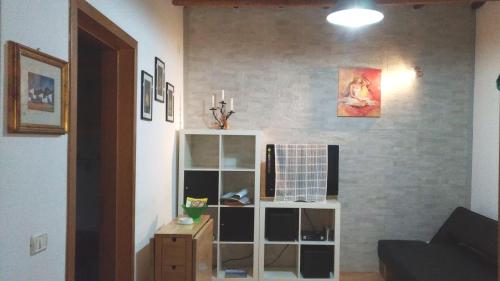 a living room with a white book shelf at Casa Vacanze Trapani Vico compagni in Trapani