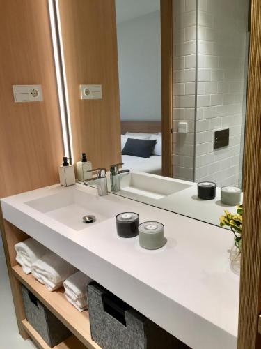 a bathroom with a white sink and a mirror at Inside Bilbao Apartments in Bilbao