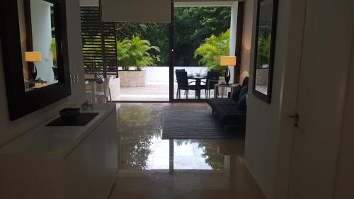 a living room with a view of a house at Quetzal Apartment in Akumal