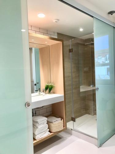 a bathroom with a shower and a sink and a mirror at Inside Bilbao Apartments in Bilbao