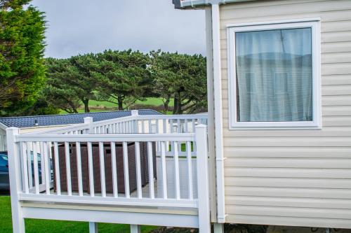 a white deck with a window on a house at Newquay Valley View in Newquay