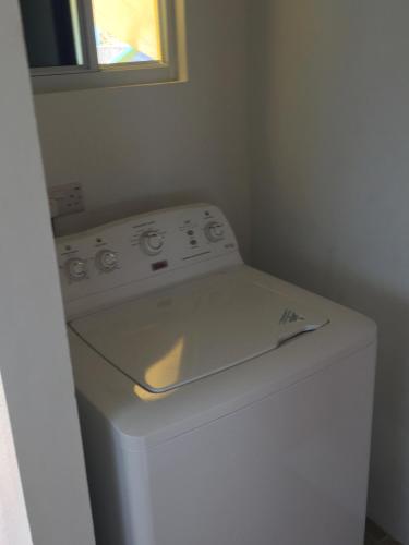 a white washer and dryer in a small room at CasaCalypso Grenada in Belmont