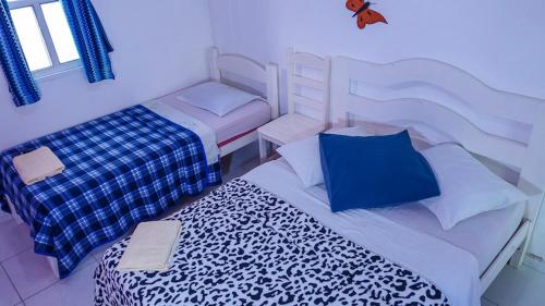 a bedroom with two beds with blue and white at Pousada Girassol in Alcobaça