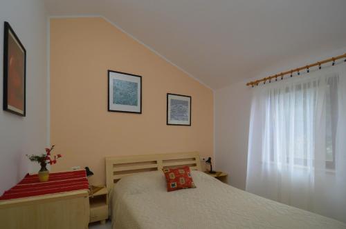 a bedroom with a bed and a window at Lavanda Vacation Home. in Medulin