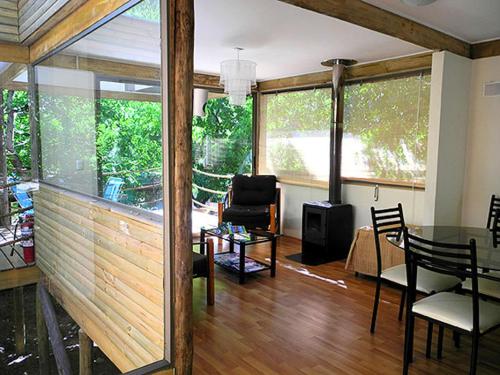 a living room with a table and some chairs at Cabañas Nogalia in San Alfonso