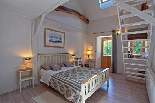 a bedroom with a white bed and a ladder at Moulin de Limayrac in Colombiès