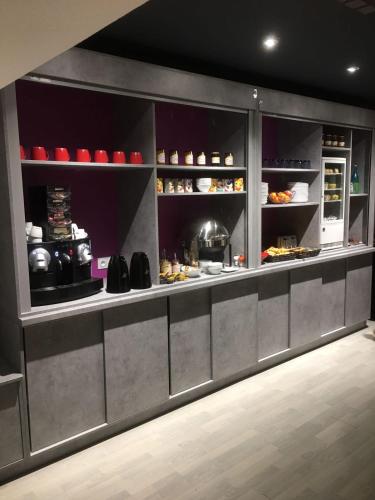 a kitchen with a counter with food on it at Hôtel Logis Restaurant La Fontaine in Mantry