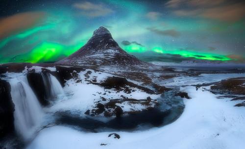 an image of a mountain with the northern lights at Við Hafið Guesthouse in Ólafsvík
